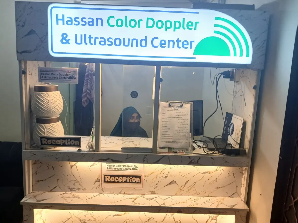 The reception desk at the centre, under the lit Hassan Color Doppler & Ultrasound Center sign