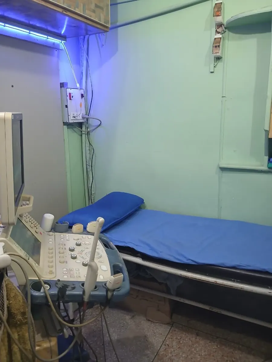 The scan room at the centre in Kahna Nau, Lahore: a Toshiba ultrasound machine beside the examination bed